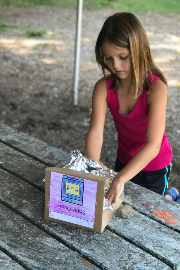 Girl making a STEM box structure